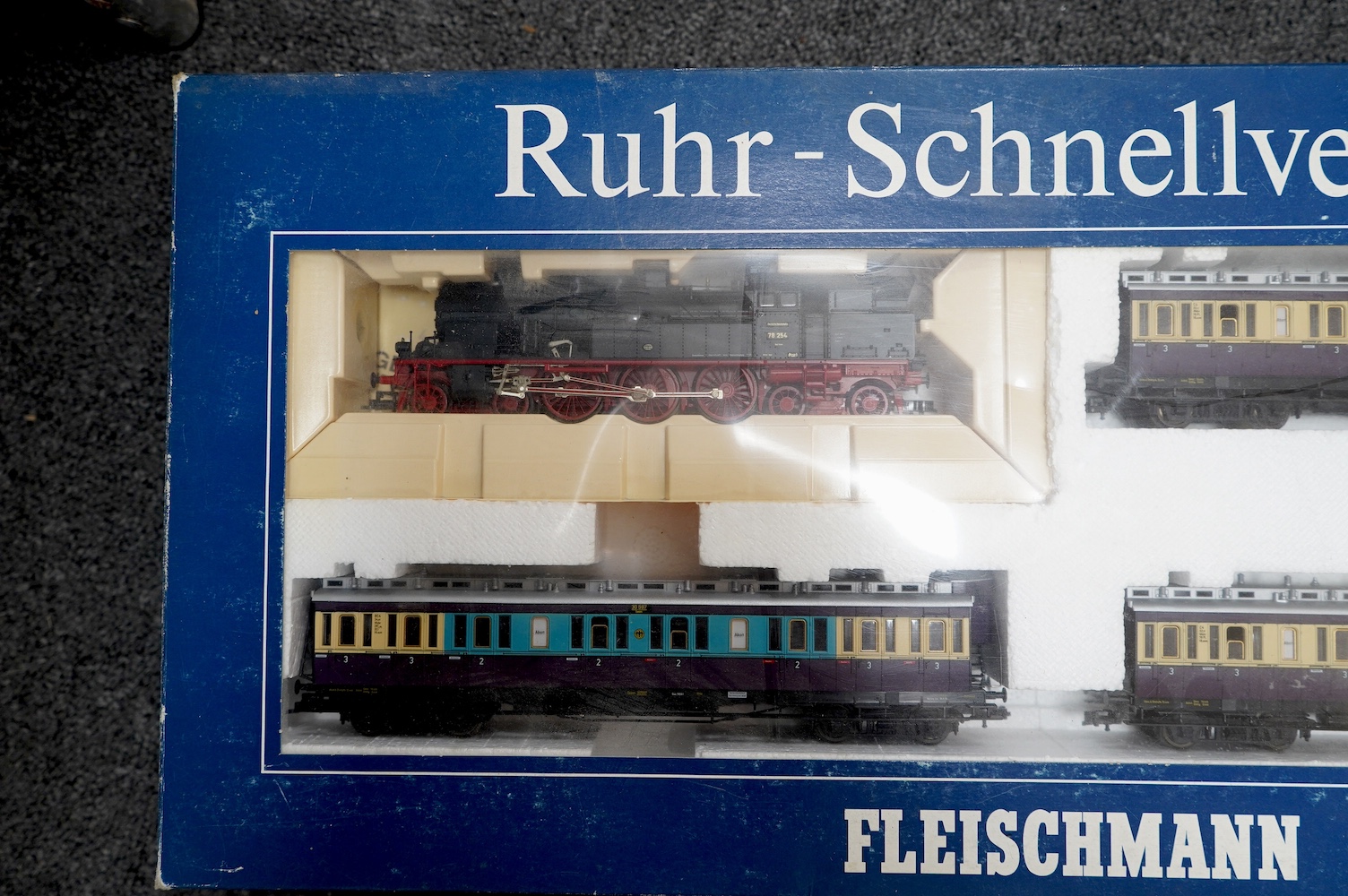 Three boxed Fleischmann HO gauge railway train sets; a passenger set with a 4-6-4T Loco and three clerestory coaches (4887), and two goods train sets, both comprising of a locomotive and an assortment of freight wagons (